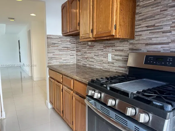 a kitchen with granite countertop stainless steel appliances and cabinets
