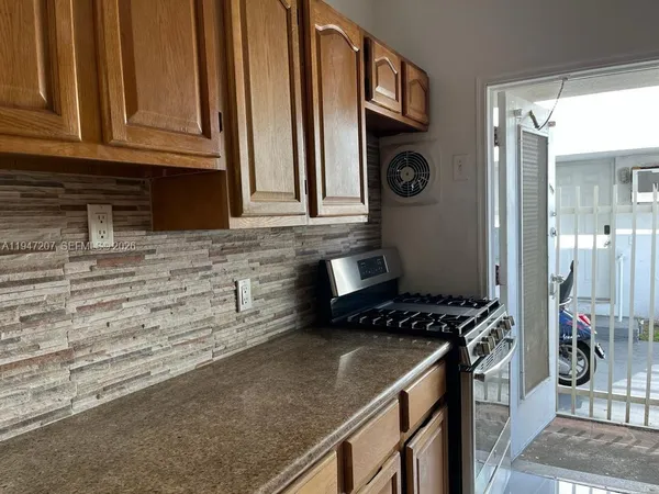 a kitchen with stainless steel appliances granite countertop a stove and a refrigerator