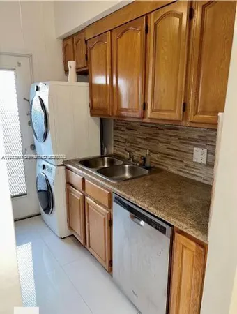 a kitchen with a sink a stove and cabinets