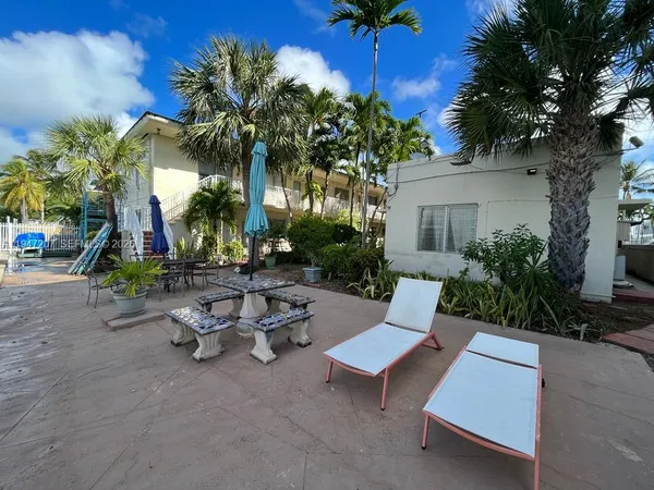 a view of a roof deck with chair and table