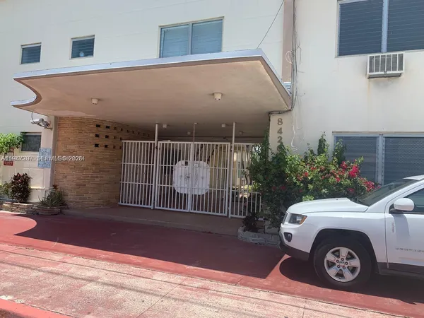 a front view of a house with parking space