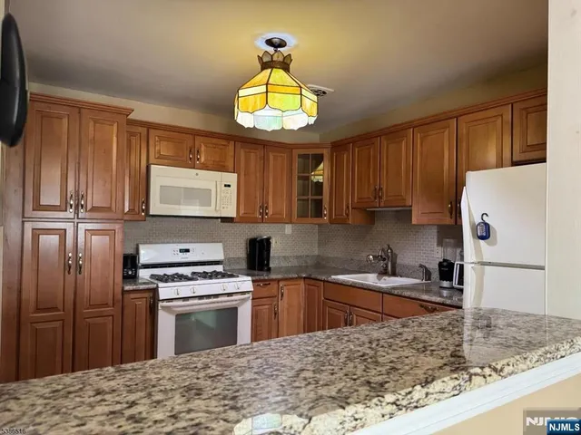 a kitchen with a stove a sink and a microwave