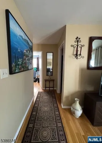 a hallway with sitting area and paintings on the wall