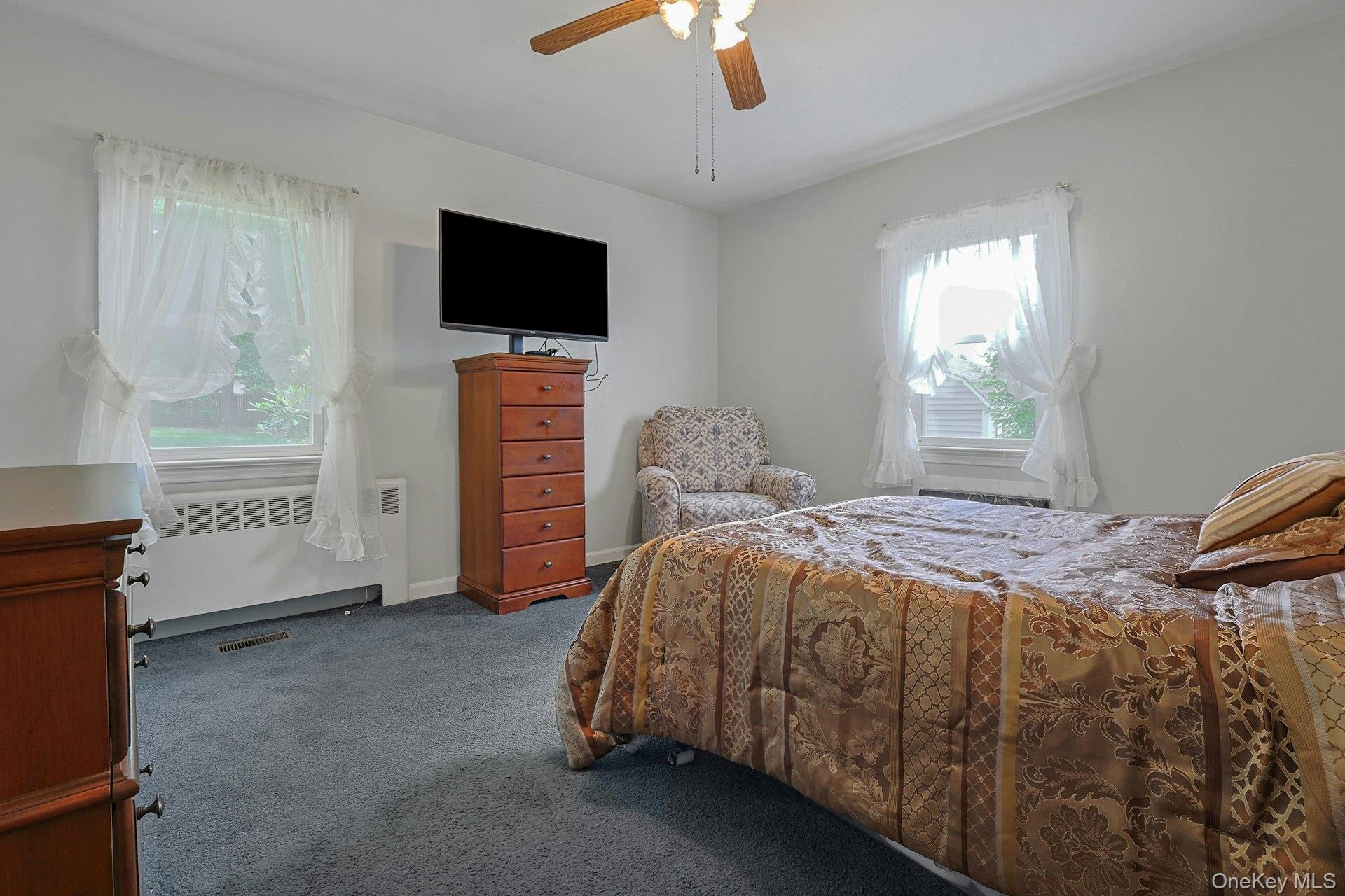 31 Townline Road Pearl River, NY 10965 - Photo 14 of 27 a bedroom with a bed and a flat tv screen on dresser