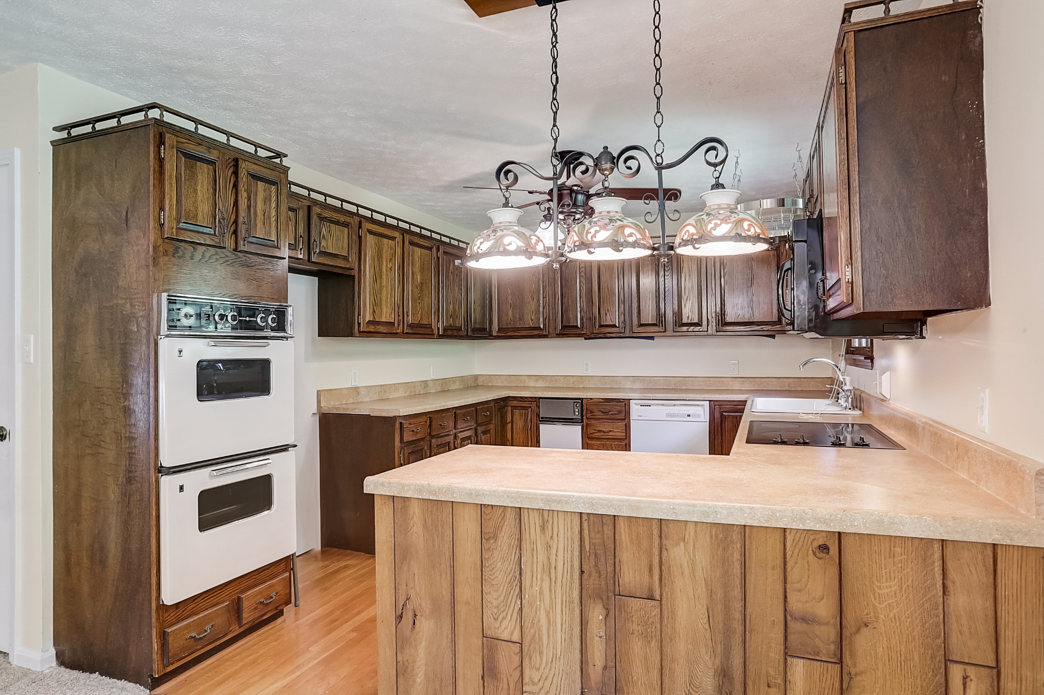 112 Lee Road Dickson, TN 37055 - Photo 7 of 29 a kitchen with stainless steel appliances a sink a stove wooden floor and cabinets