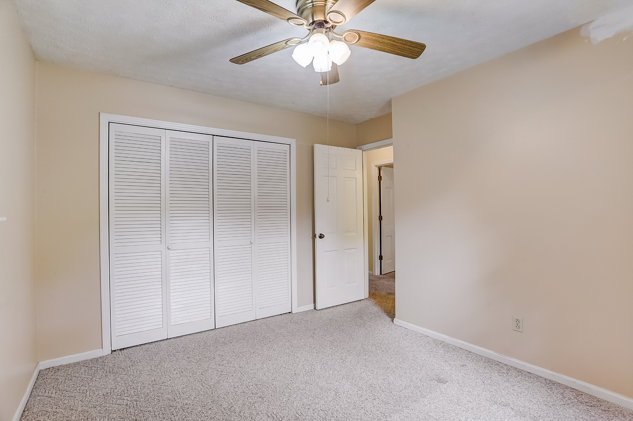 112 Lee Road Dickson, TN 37055 - Photo 10 of 29 an empty room with closet and a chandelier fan