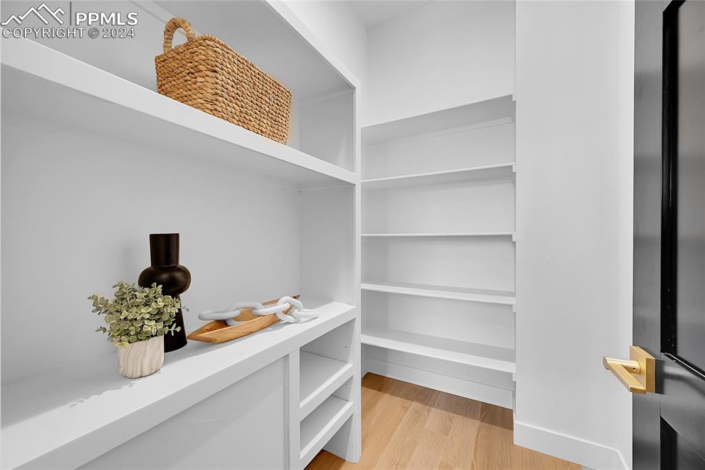 5549 Remuda Ranch Parkway Sedalia, CO 80135 - Photo 12 of 39 a room with a potted plant on the counter and a wooden floor