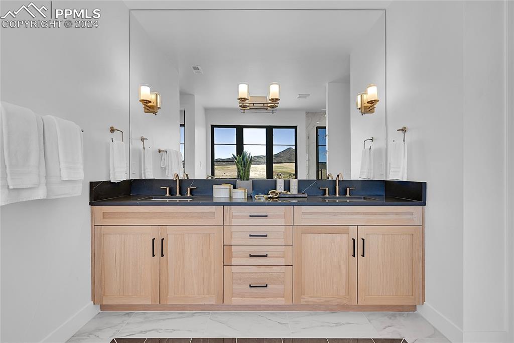 5549 Remuda Ranch Parkway Sedalia, CO 80135 - Photo 20 of 39 a bathroom with a sink and a mirror
