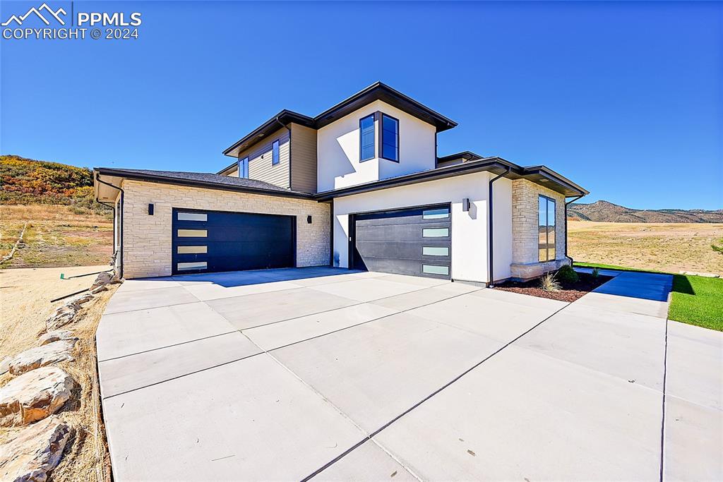 5549 Remuda Ranch Parkway Sedalia, CO 80135 - Photo 2 of 39 a front view of a house with a garage
