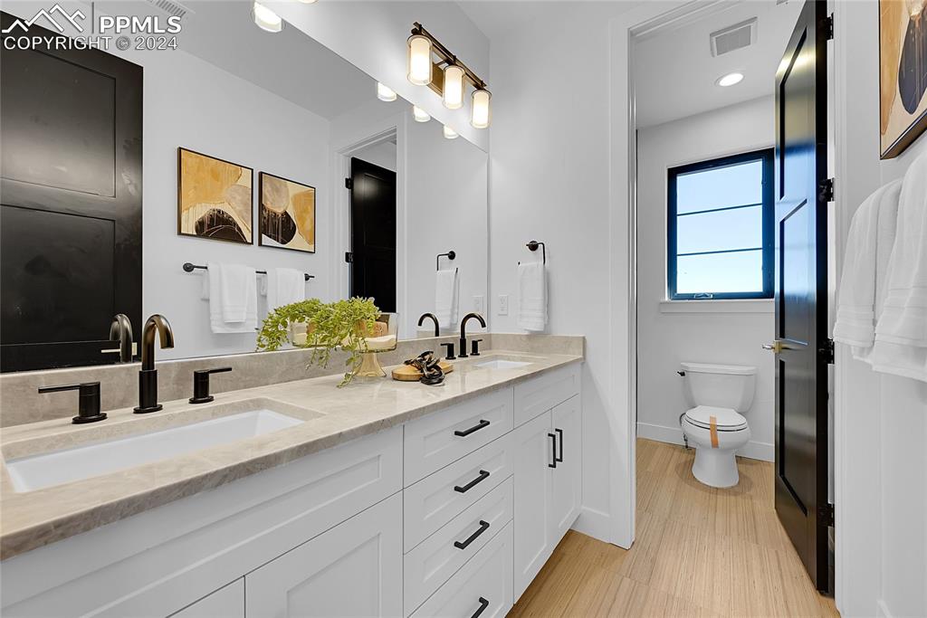 5549 Remuda Ranch Parkway Sedalia, CO 80135 - Photo 25 of 39 a bathroom with a double vanity sink and a mirror