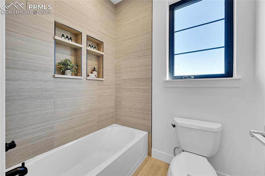 5549 Remuda Ranch Parkway Sedalia, CO 80135 - Photo 26 of 39 a bathroom with a toilet a sink and bathtub
