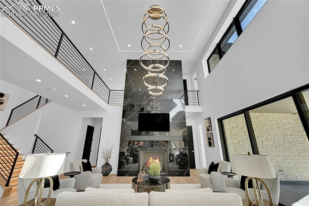 5549 Remuda Ranch Parkway Sedalia, CO 80135 - Photo 6 of 39 a living room with fireplace furniture and a flat screen tv