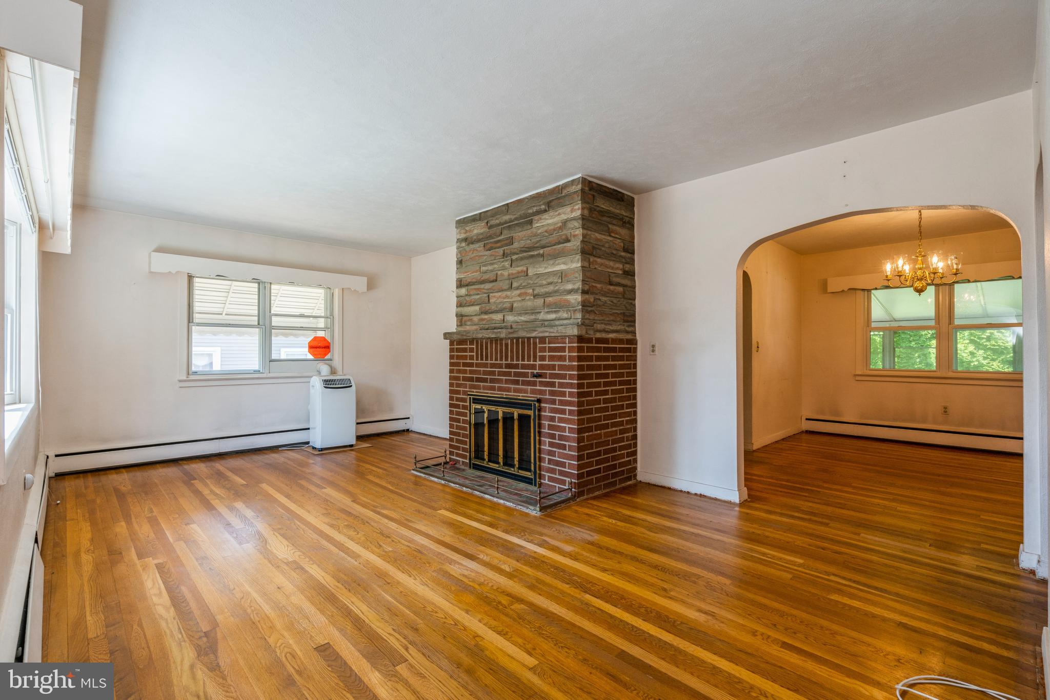 112 Wilburtha Road Ewing, NJ 08628 - Photo 4 of 21 an empty room with wooden floor and windows