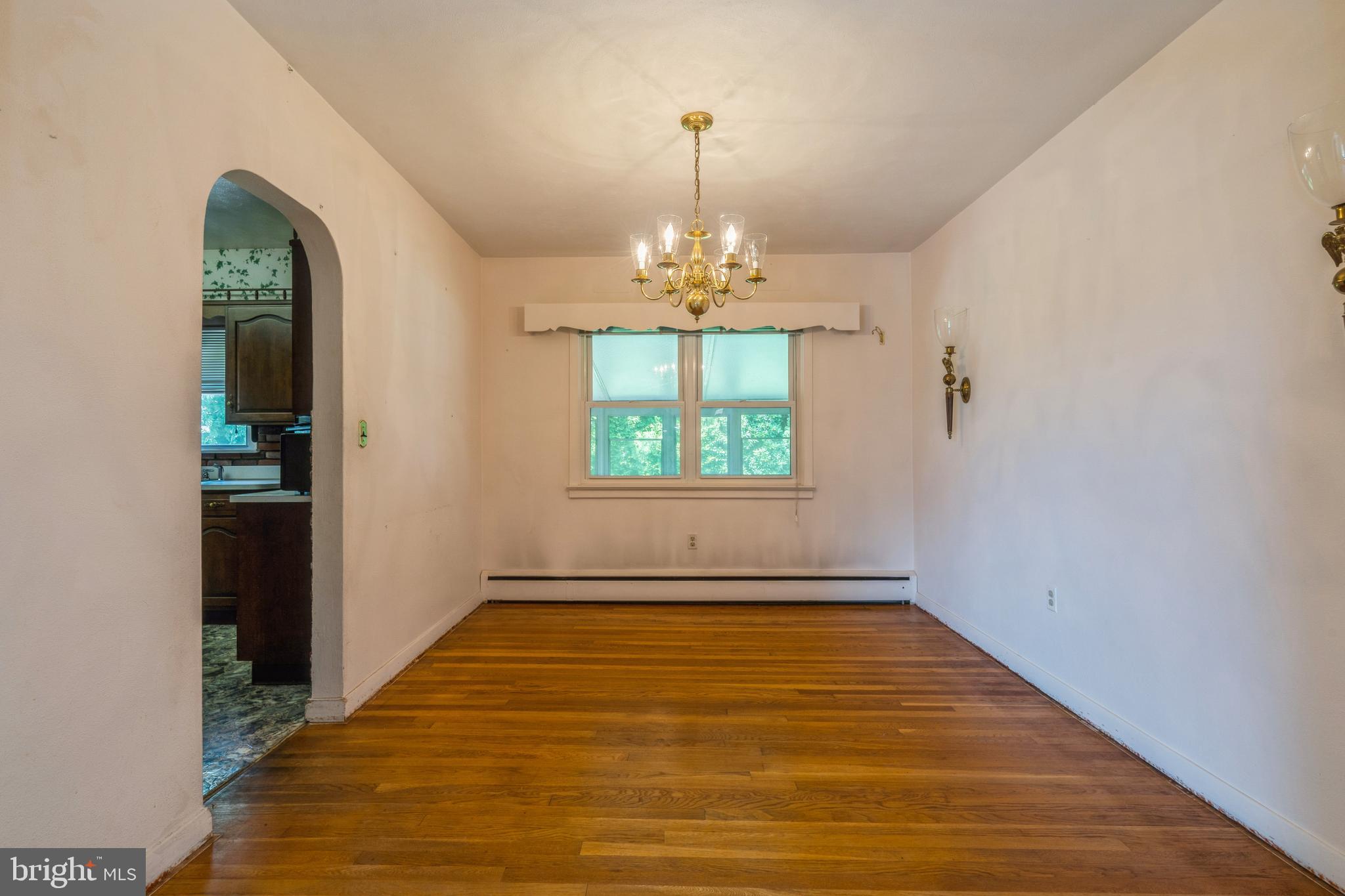 112 Wilburtha Road Ewing, NJ 08628 - Photo 6 of 21 an empty room with windows and chandelier