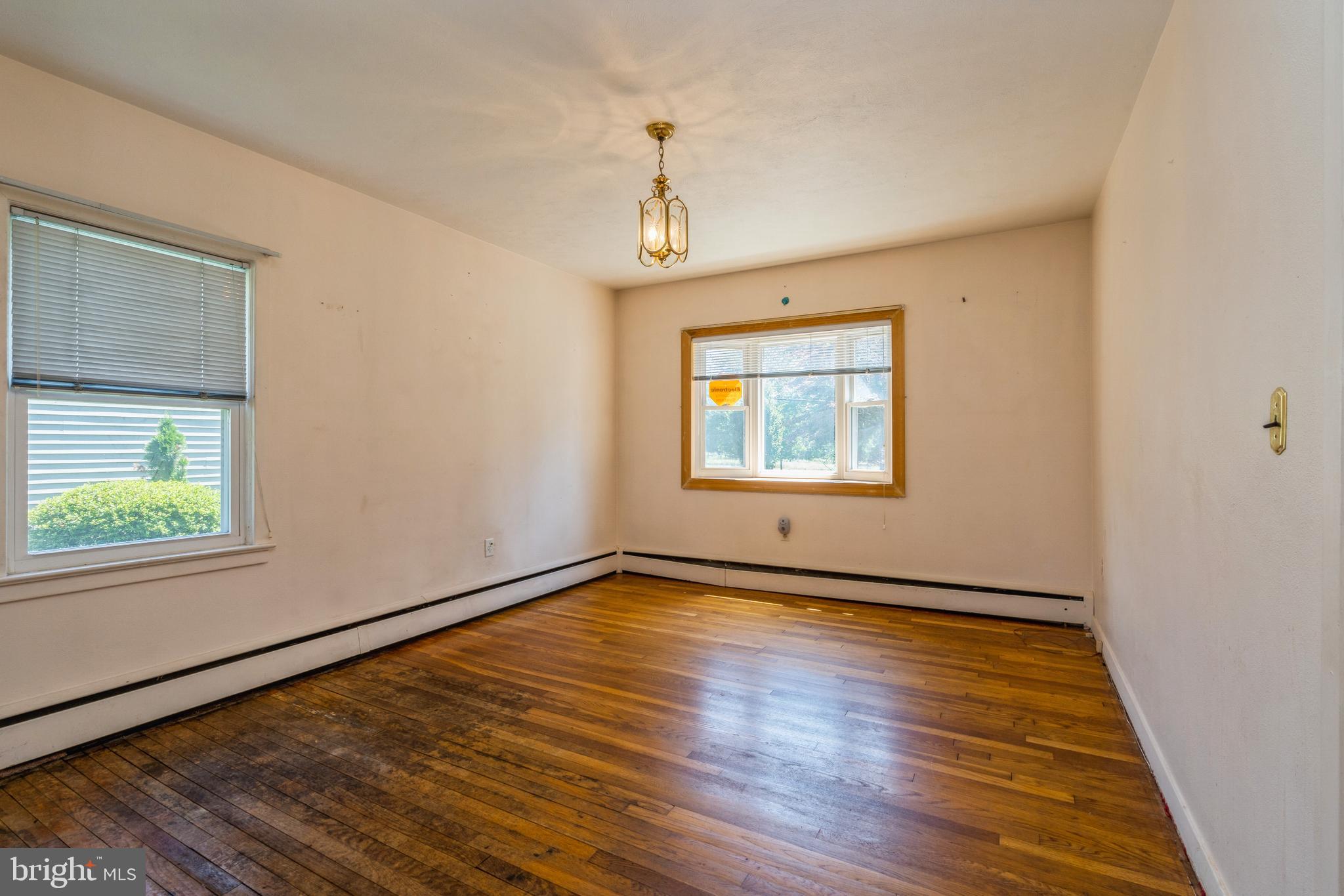 112 Wilburtha Road Ewing, NJ 08628 - Photo 8 of 21 an empty room with wooden floor windows and entrance