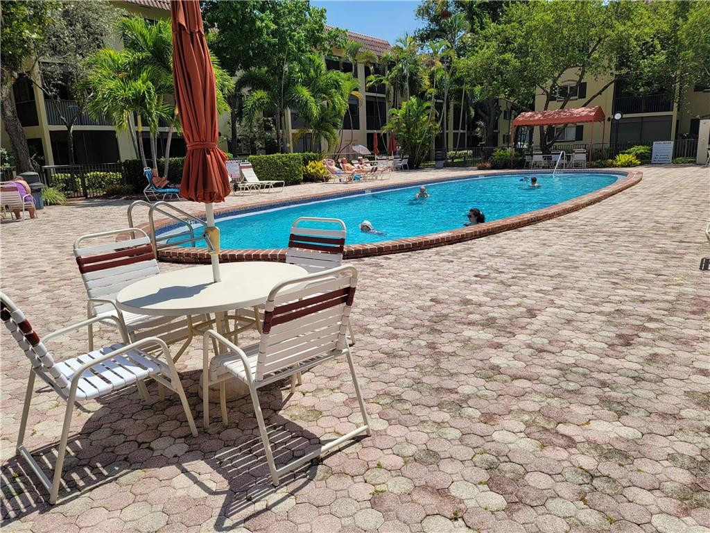 251 South Cypress Road, Unit 112 Pompano Beach, FL 33060 - Photo 12 of 20 a view of a chairs and table in the patio