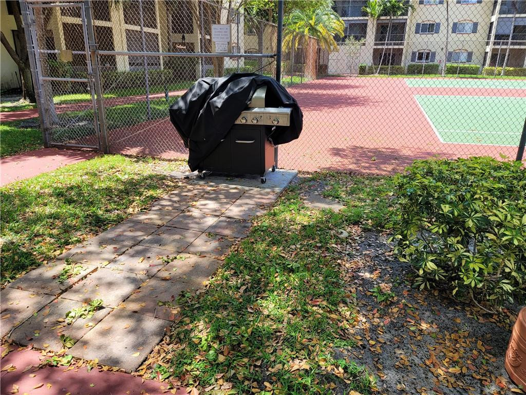 251 South Cypress Road, Unit 112 Pompano Beach, FL 33060 - Photo 14 of 20 a front view of a house with a yard