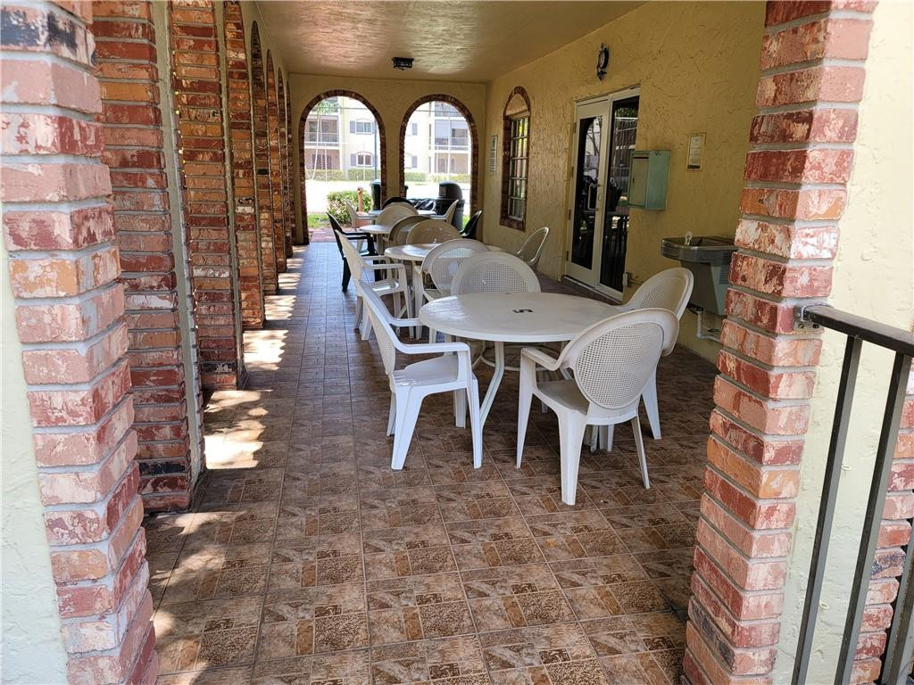 251 South Cypress Road, Unit 112 Pompano Beach, FL 33060 - Photo 15 of 20 a view of a patio with table and chairs