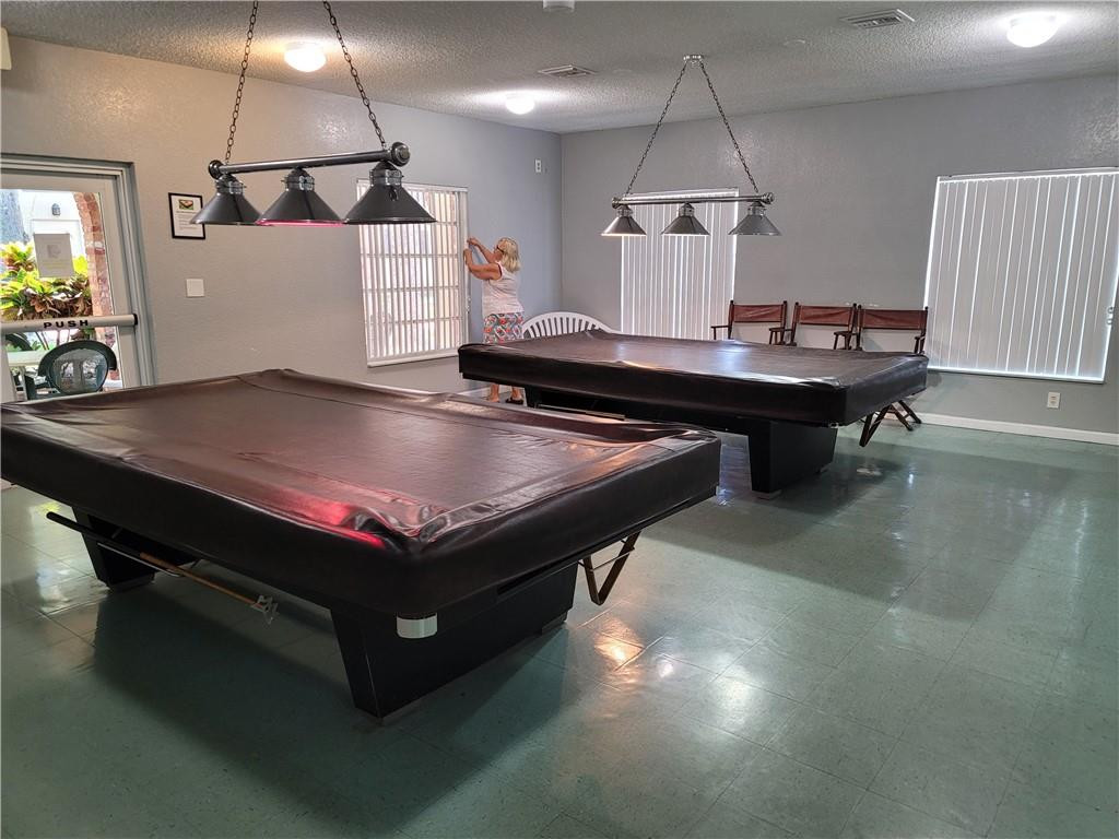 251 South Cypress Road, Unit 112 Pompano Beach, FL 33060 - Photo 16 of 20 a room with pool table and a chandelier