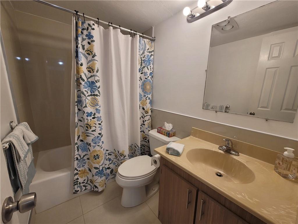 251 South Cypress Road, Unit 112 Pompano Beach, FL 33060 - Photo 6 of 20 a bathroom with a sink toilet and shower