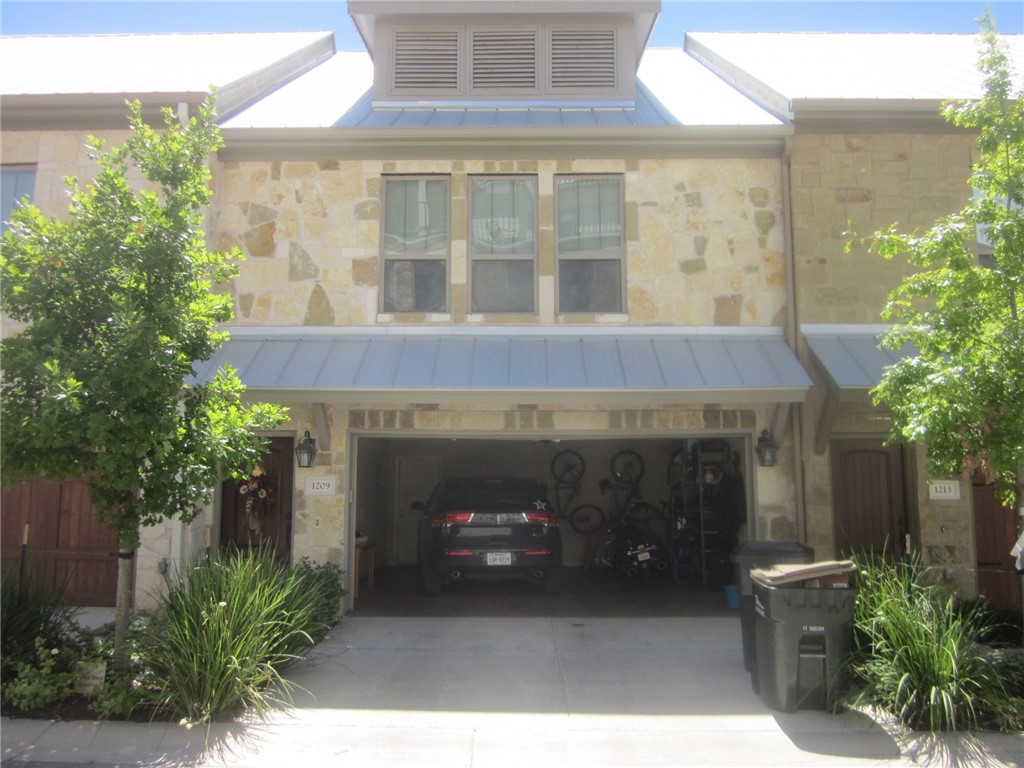a front view of a house with plants