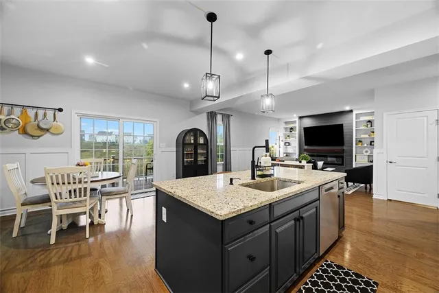a large kitchen with kitchen island a sink a counter space and stainless steel appliances
