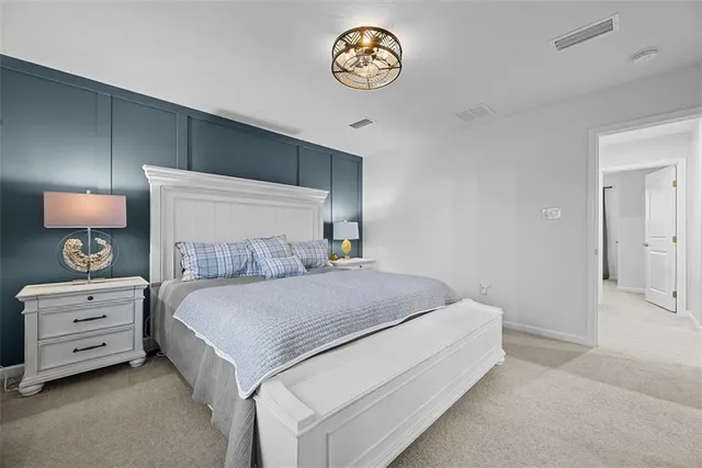 a bedroom with a bed and a lamp