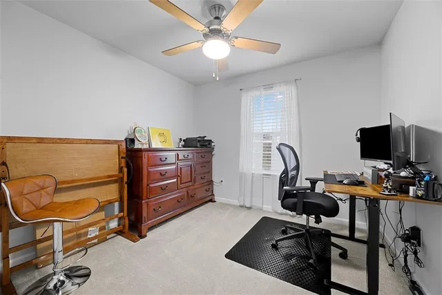 a view of a workspace with furniture and a window