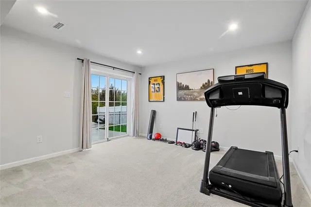 a room with gym equipment and a large window
