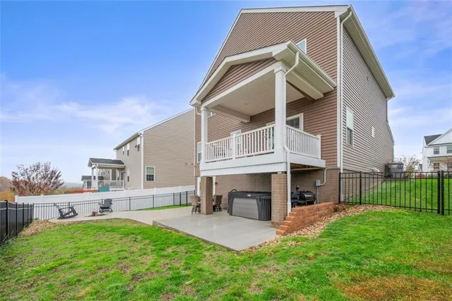 a view of house with a yard and deck