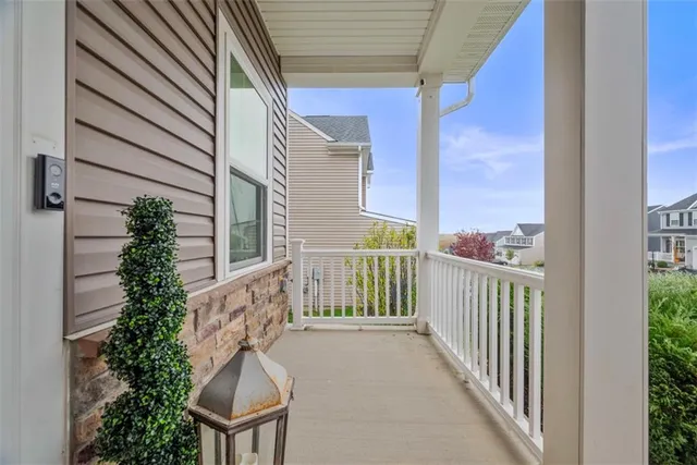 a view of a balcony with chair and wooden fence