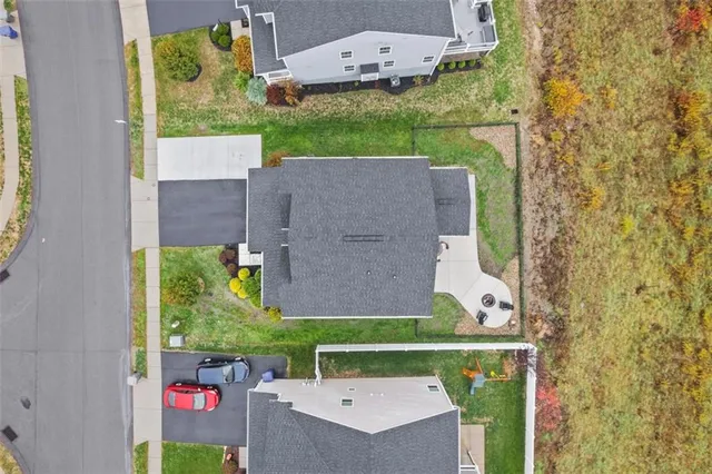 an aerial view of a house with a yard