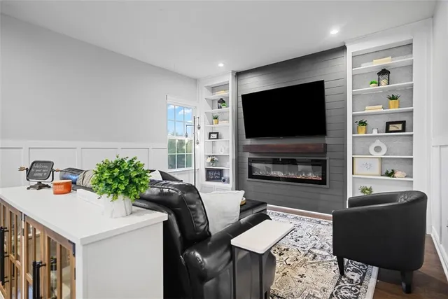 a living room with furniture a flat screen tv and a fireplace