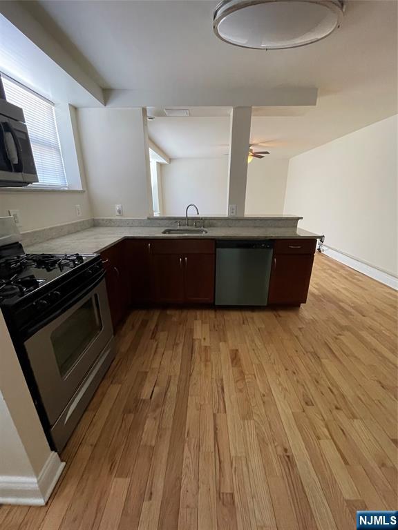 280-320 Oak Street, Unit 306TG Ridgewood, NJ 07450 - Photo 3 of 22 a kitchen with wooden floors and a stove