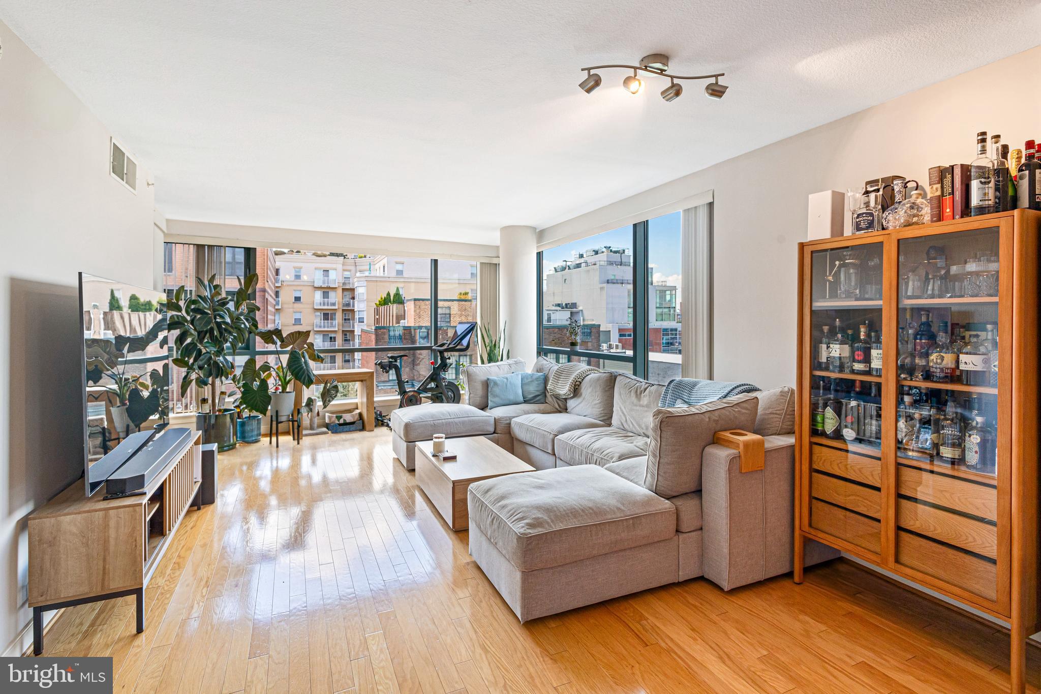 1117 10th Street Northwest, Unit 804 Washington, DC 20001 - Photo 11 of 46 a living room with furniture and a flat screen tv