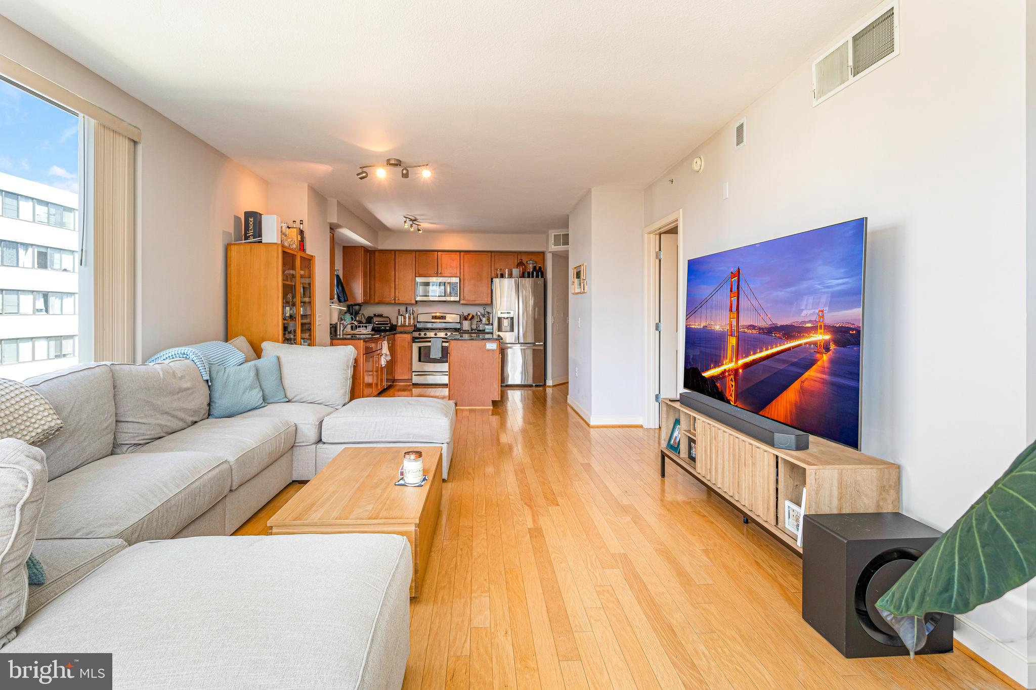 1117 10th Street Northwest, Unit 804 Washington, DC 20001 - Photo 12 of 46 a living room with furniture and wooden floor