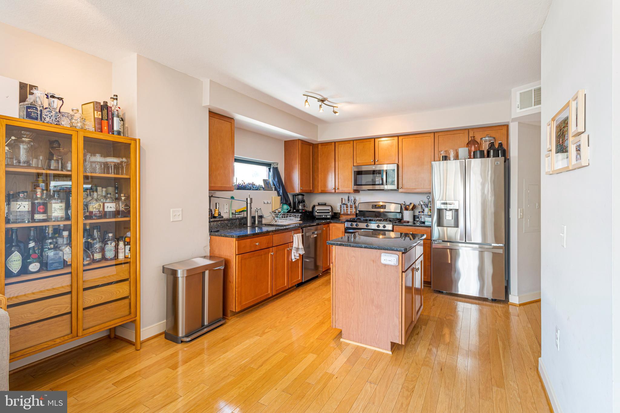 1117 10th Street Northwest, Unit 804 Washington, DC 20001 - Photo 13 of 46 a kitchen with stainless steel appliances a refrigerator and a stove top oven