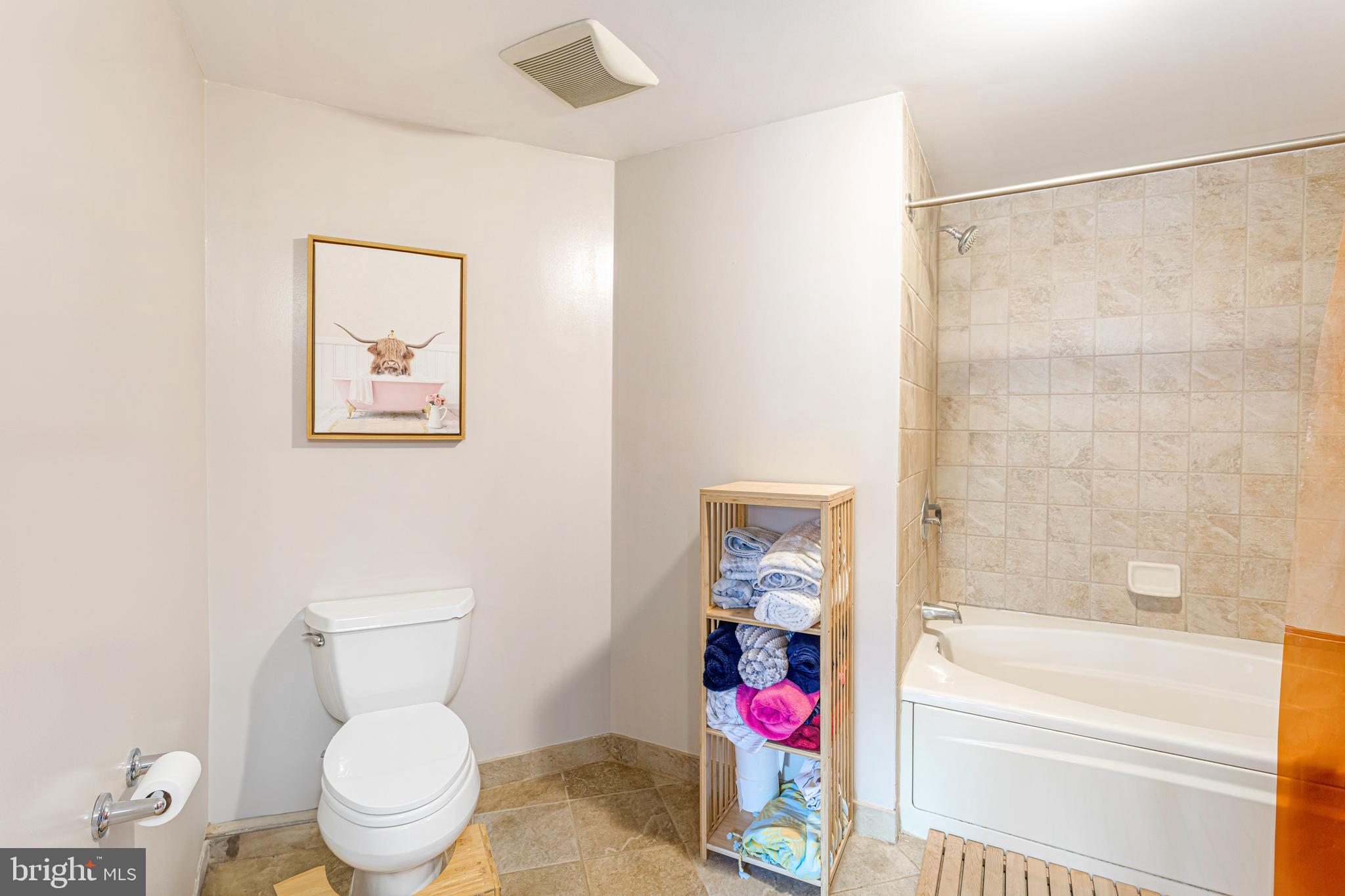 1117 10th Street Northwest, Unit 804 Washington, DC 20001 - Photo 26 of 46 a white toilet sitting next to a bath tub and a shower