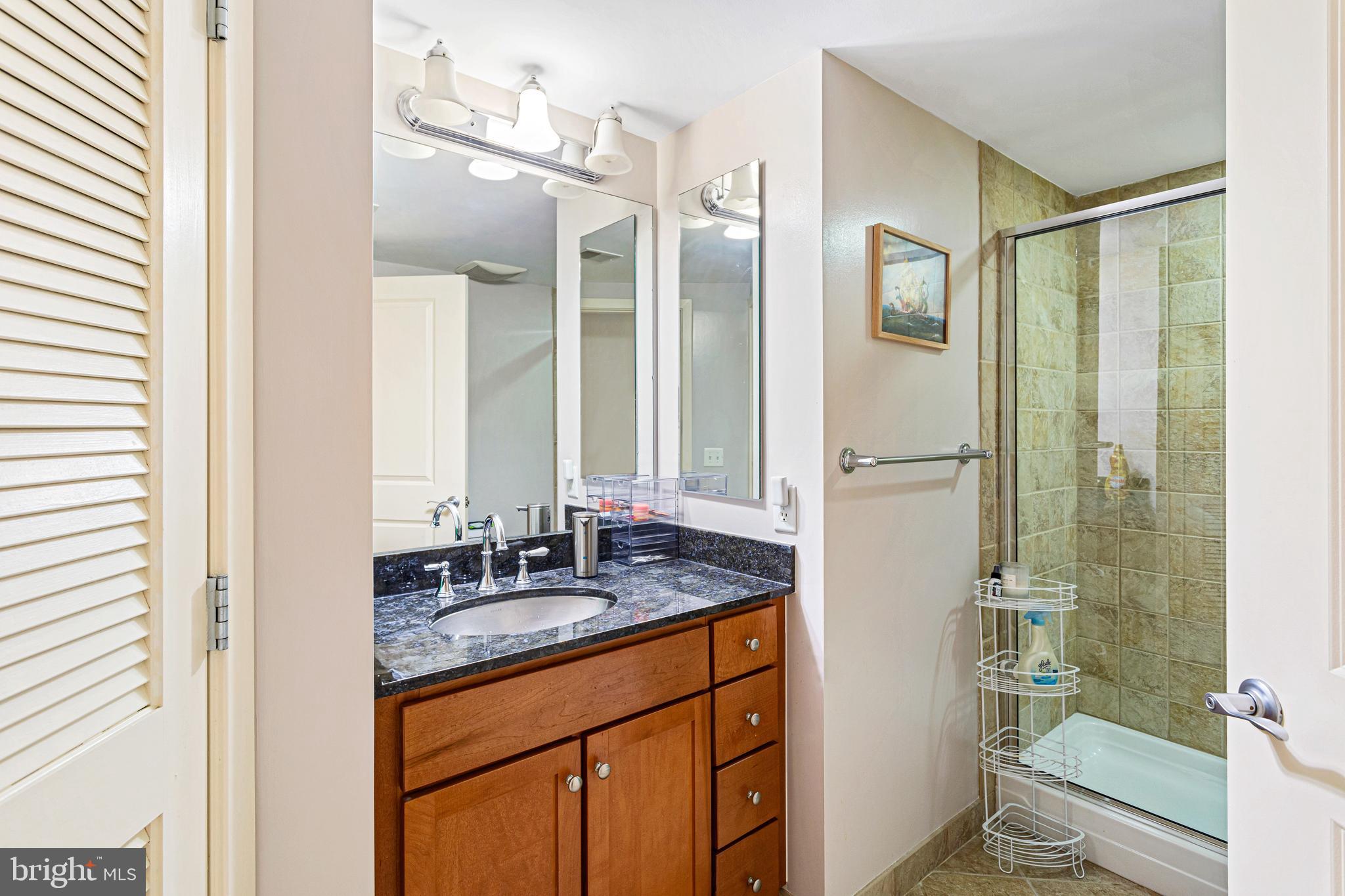 1117 10th Street Northwest, Unit 804 Washington, DC 20001 - Photo 33 of 46 a bathroom with a granite countertop sink mirror and double