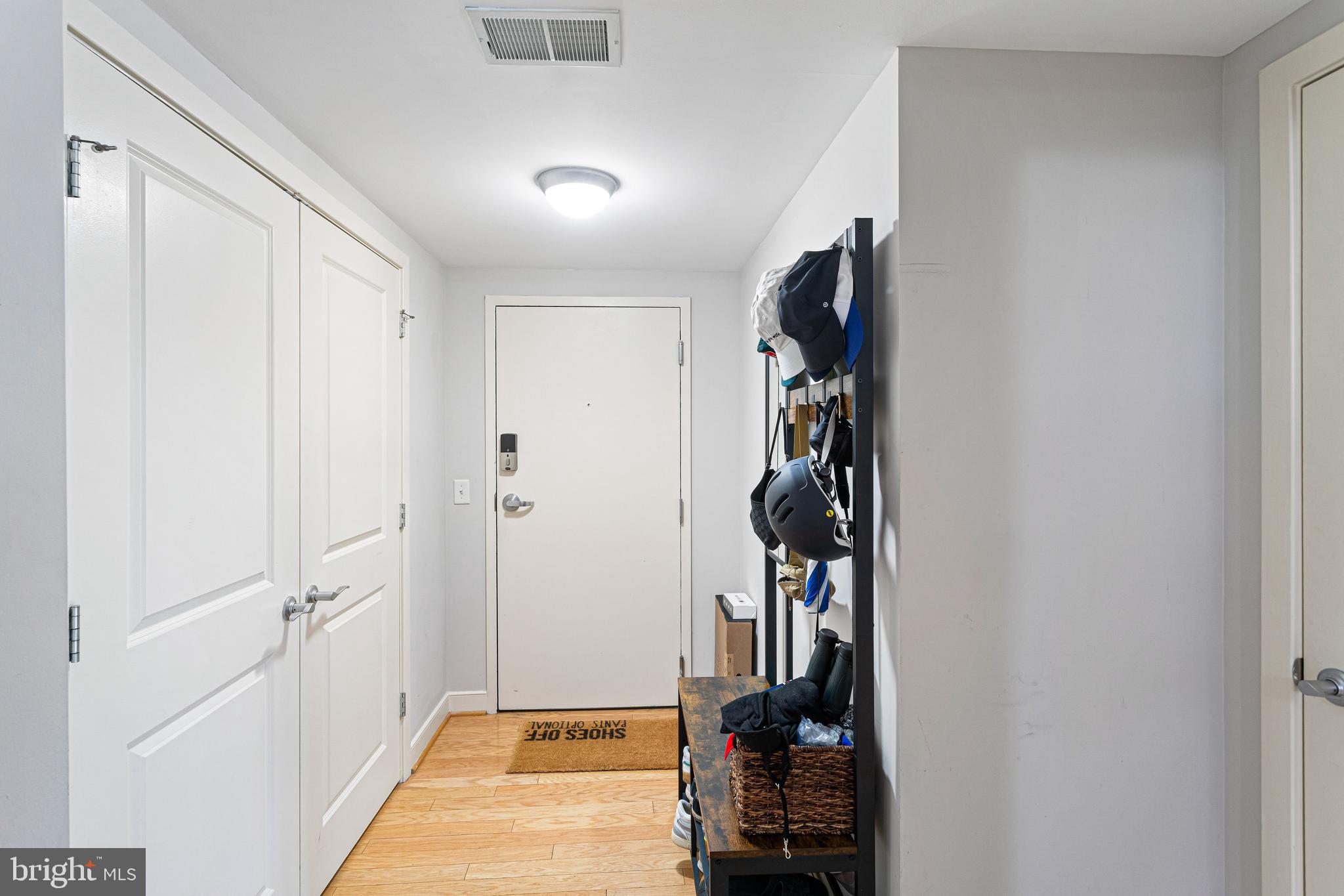 1117 10th Street Northwest, Unit 804 Washington, DC 20001 - Photo 9 of 46 a view of a hallway with closet and a living room