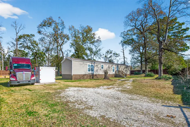 a view of house with a yard