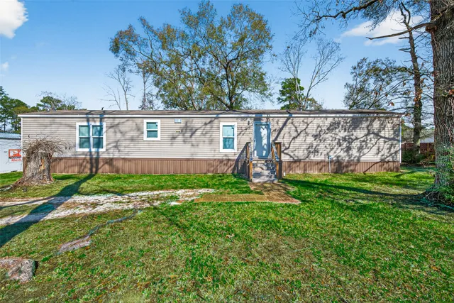 a view of a wooden house with large windows