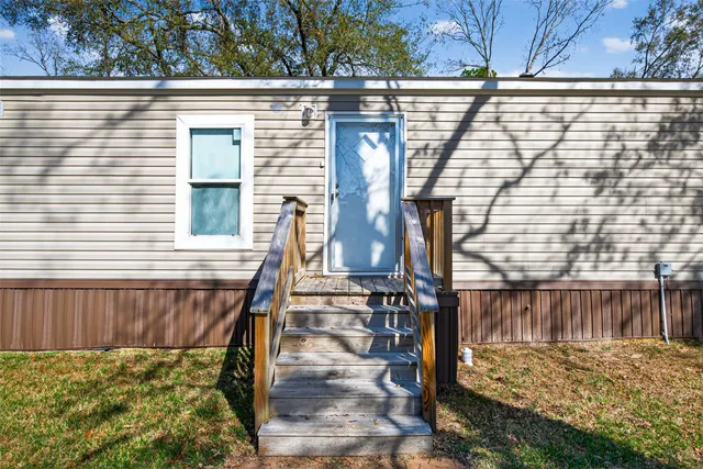 a view of a kitchen with a refrigerator and a sink