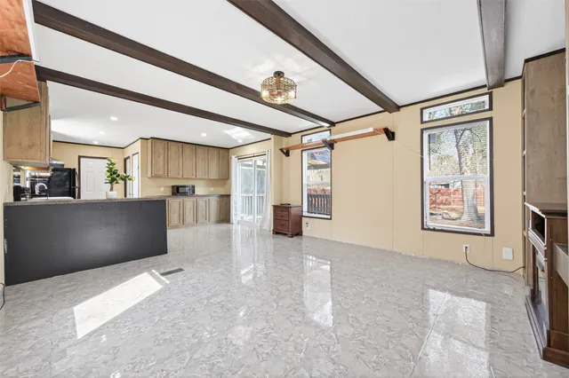 a view of a big room with furniture and windows