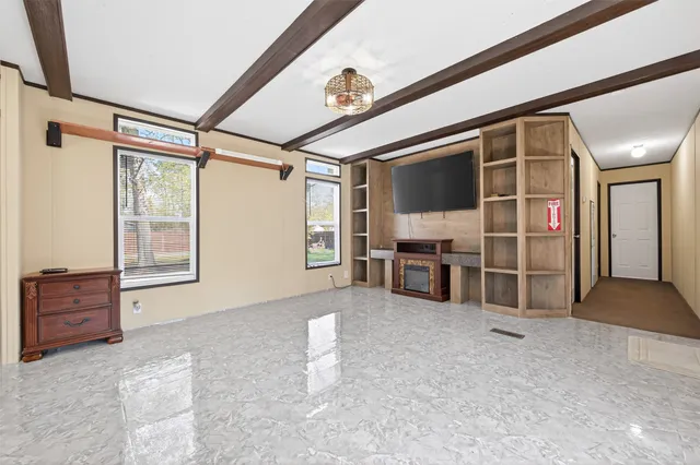 a view of kitchen with refrigerator and windows