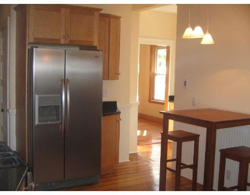 99 Parkton Road, Unit 1 Boston, MA 02130 - Photo 5 of 16 a kitchen with a refrigerator and a table