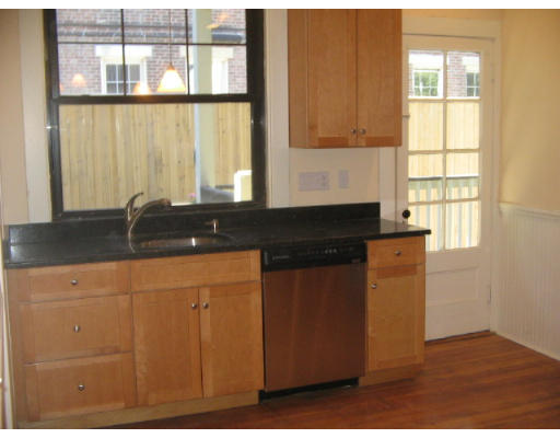 99 Parkton Road, Unit 1 Boston, MA 02130 - Photo 6 of 16 a kitchen with granite countertop a sink and a window