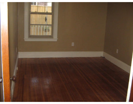 99 Parkton Road, Unit 1 Boston, MA 02130 - Photo 9 of 16 an empty room with wooden floor and windows