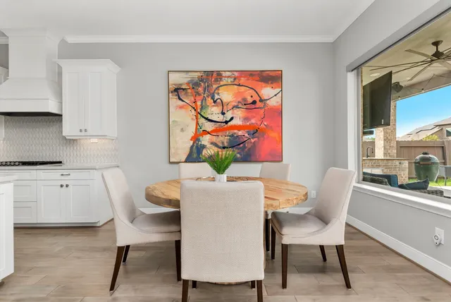 a dining room with furniture and wooden floor