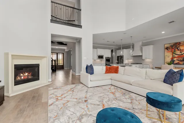 a living room with furniture a fireplace and a flat screen tv